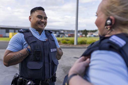 Two Corrections Officers stood outside having a chat