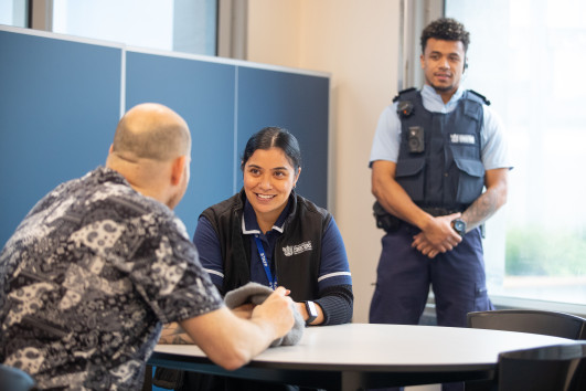 Corrections staff chat with an individual in prison